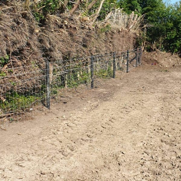 Plastic Fence Posts with barbed wire Installed in a field farm ireland