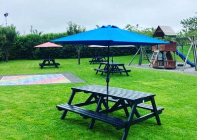 A frame picnic bench with umbrella at Mollie Moos Pet Farm NGP